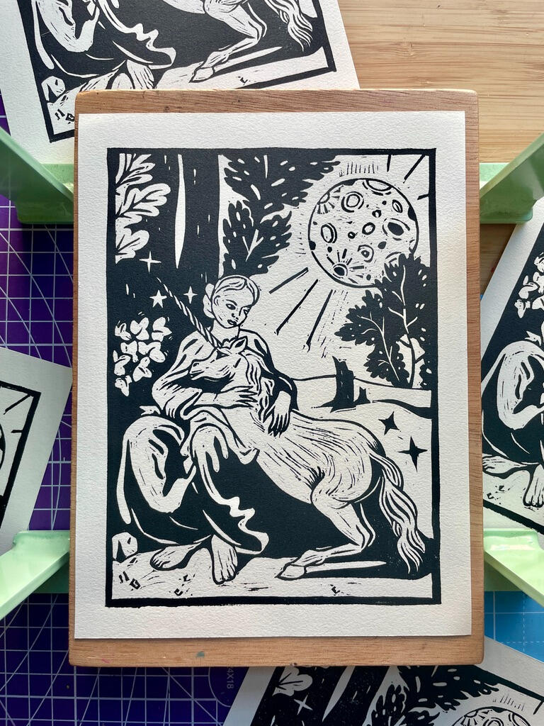 Virgin with a Unicorn | buy prints Linocut print of a unicorn resting on a woman's lap, outside under an oversized full moon