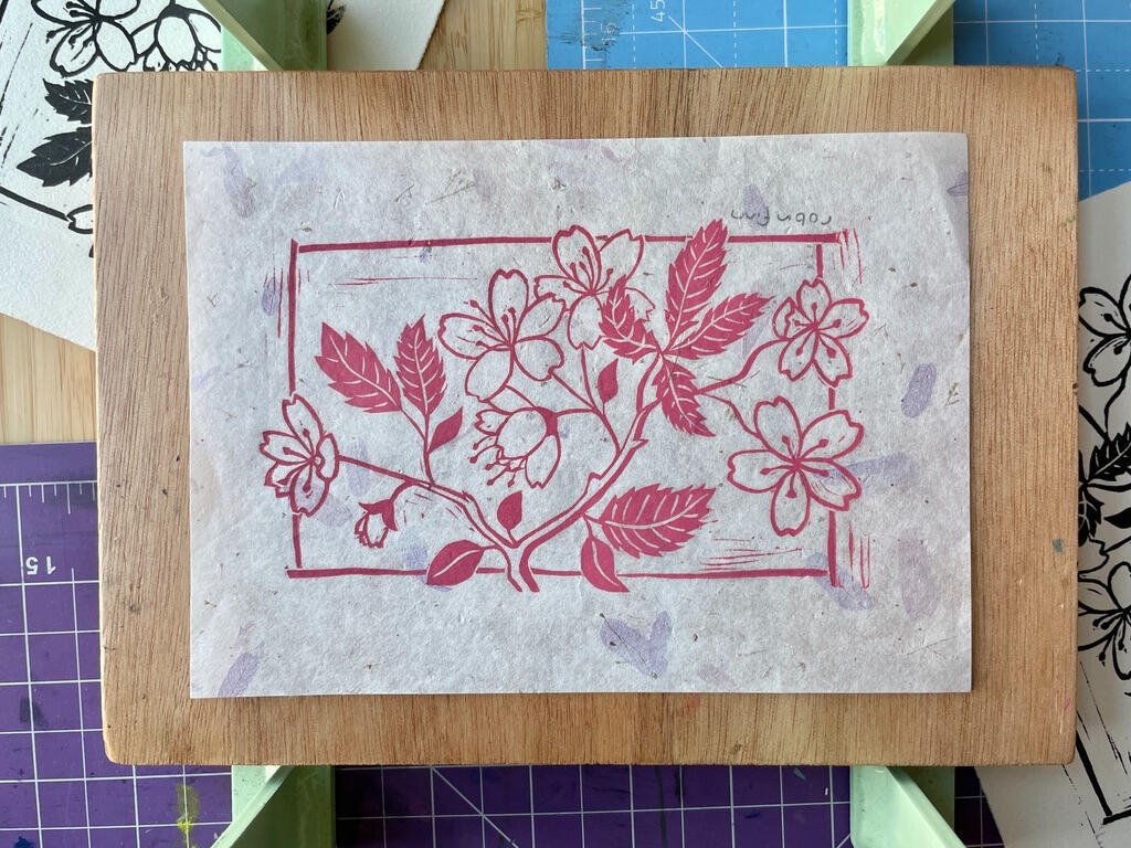 Cherry Blossoms | buy prints Linocut print of a cherry blossom branch in pink ink on decorative petal paper.
