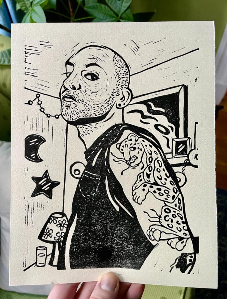 Linocut print of a man with a shaved head, beard stubble, and a large leopard bicep tattoo.